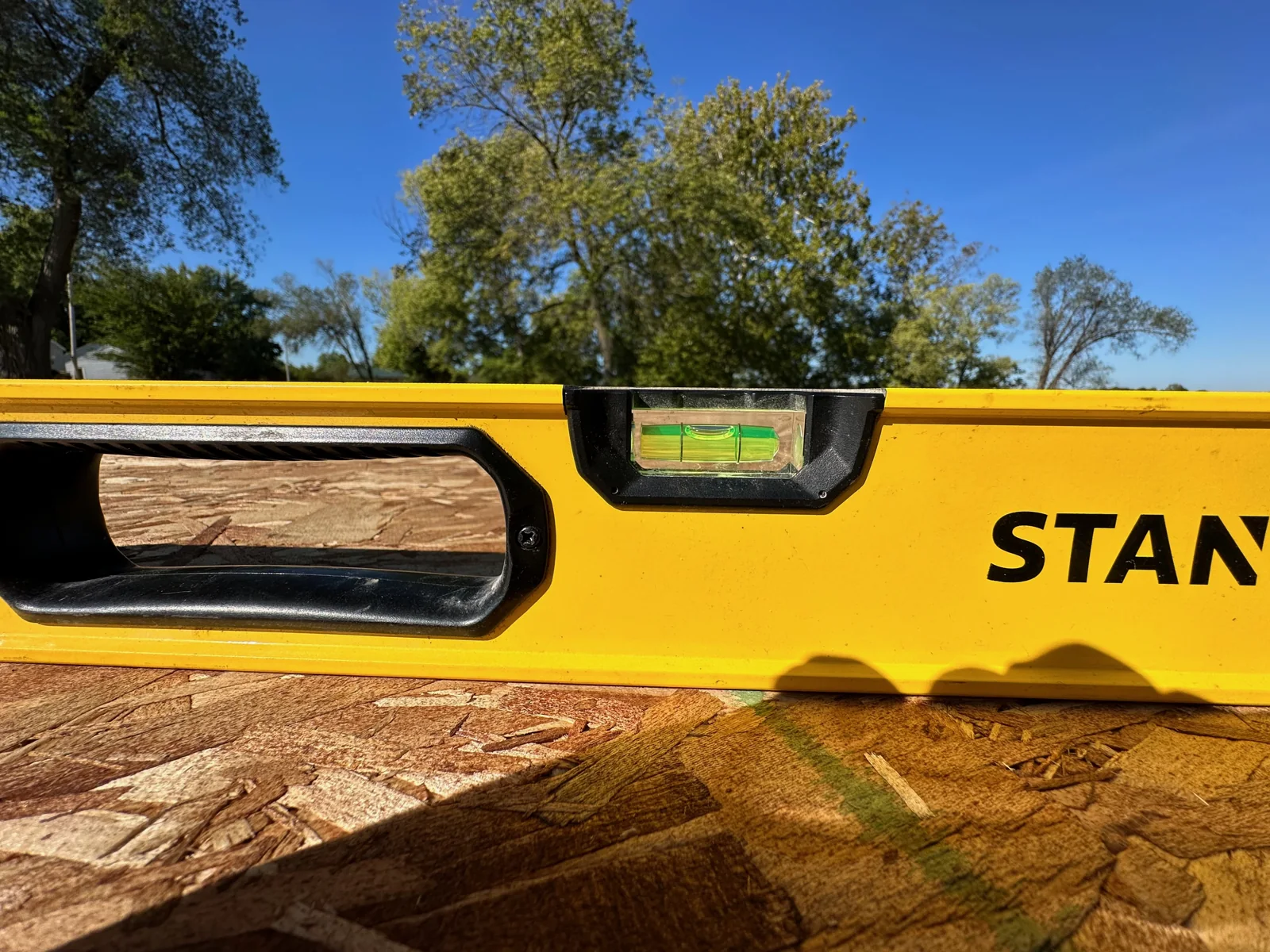 A level resting on wood during foundation work.