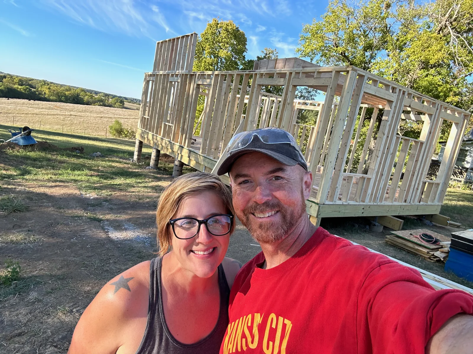 Brian and Calleen in front of the early house framing.