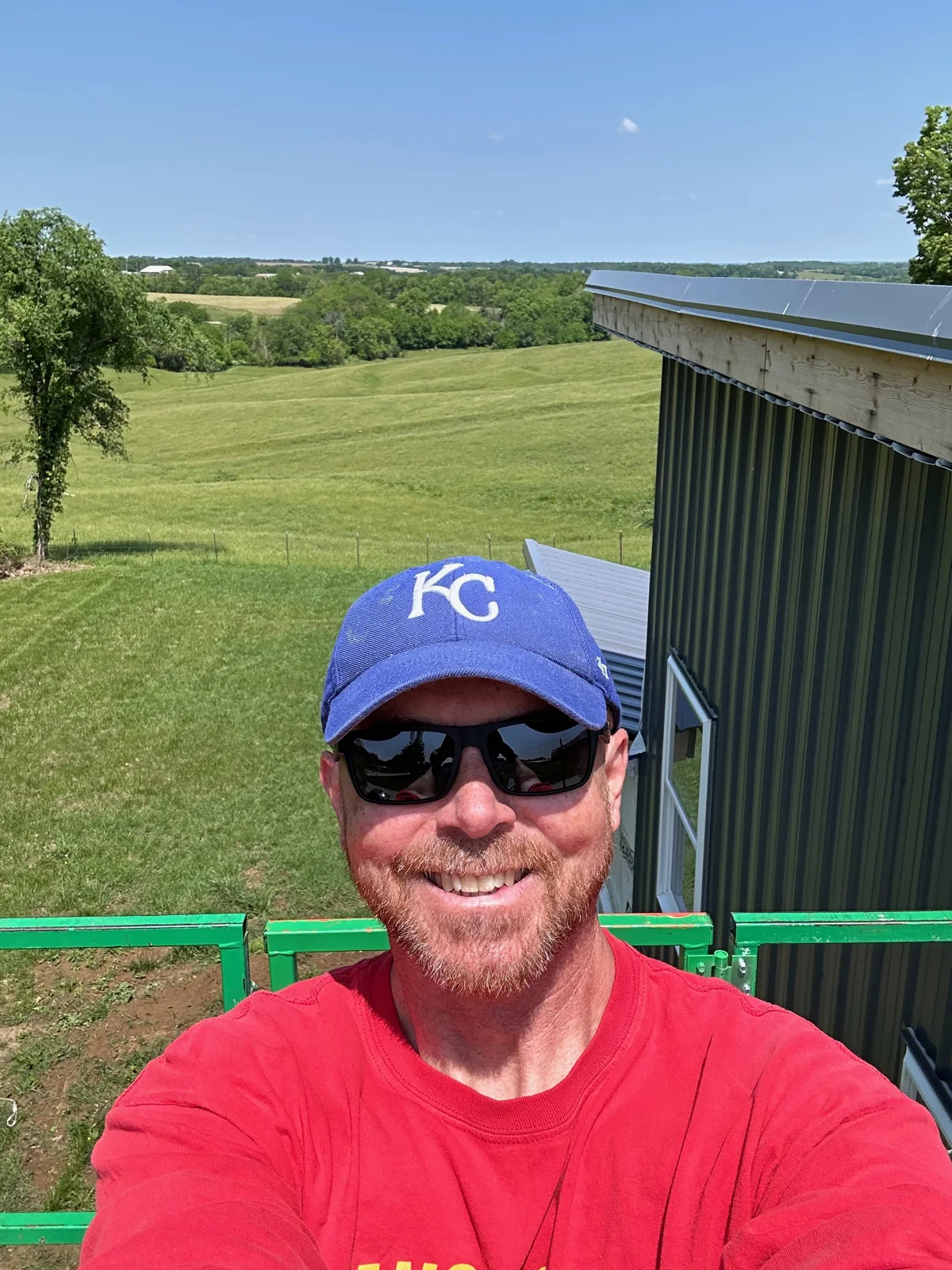 Brian in a lift with open fields visible behind him.