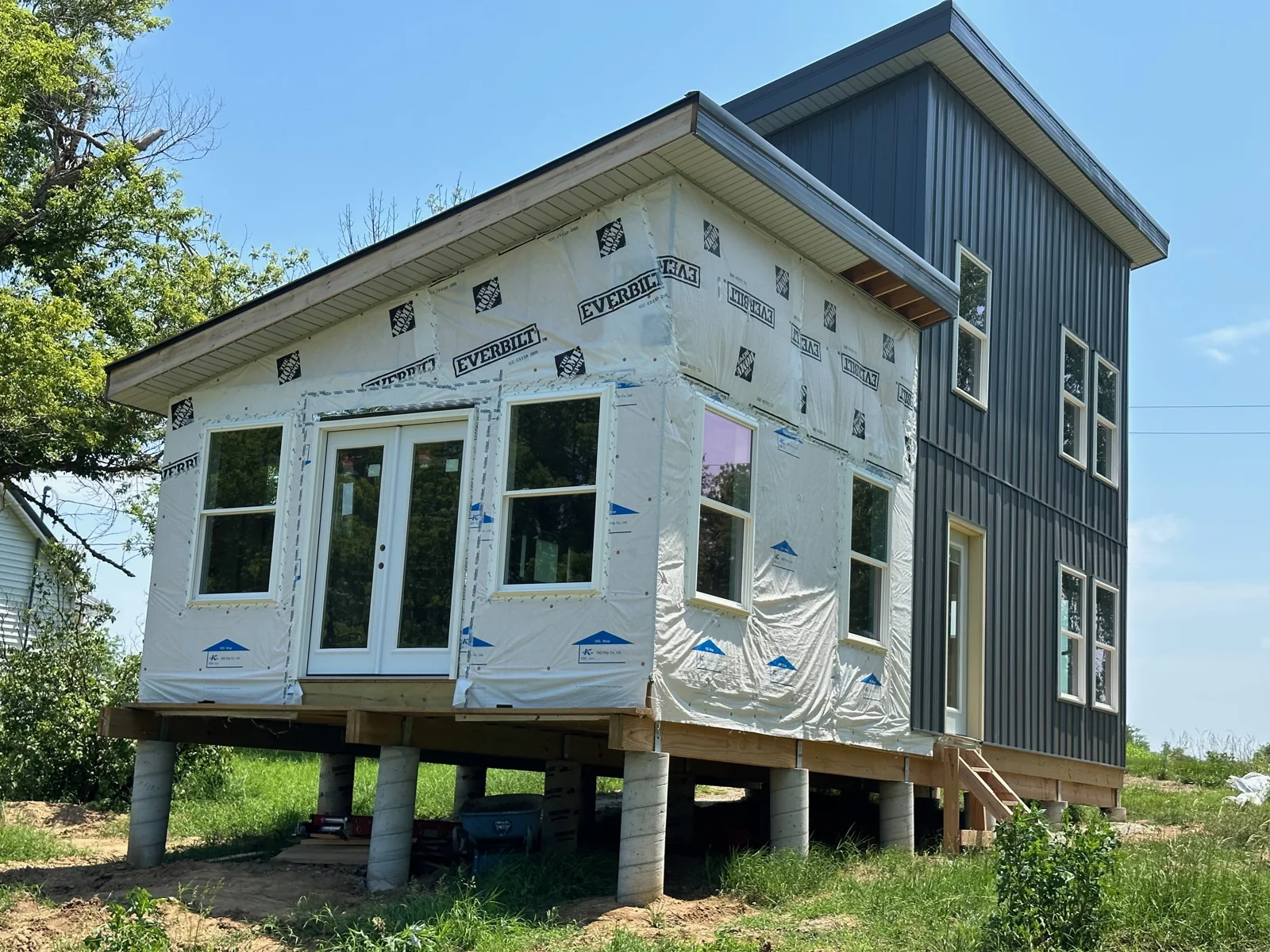 Katy Manor with windows, doors, house wrap, and partial siding installed.