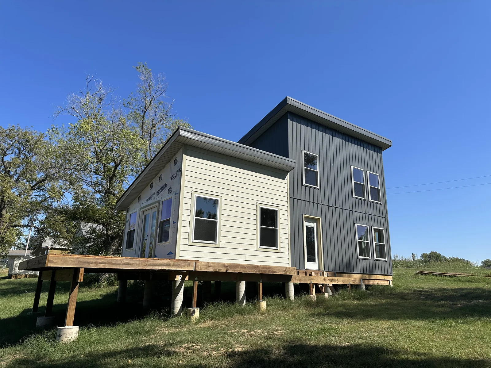 Katy Manor with siding completed and deck framing around the front and side.