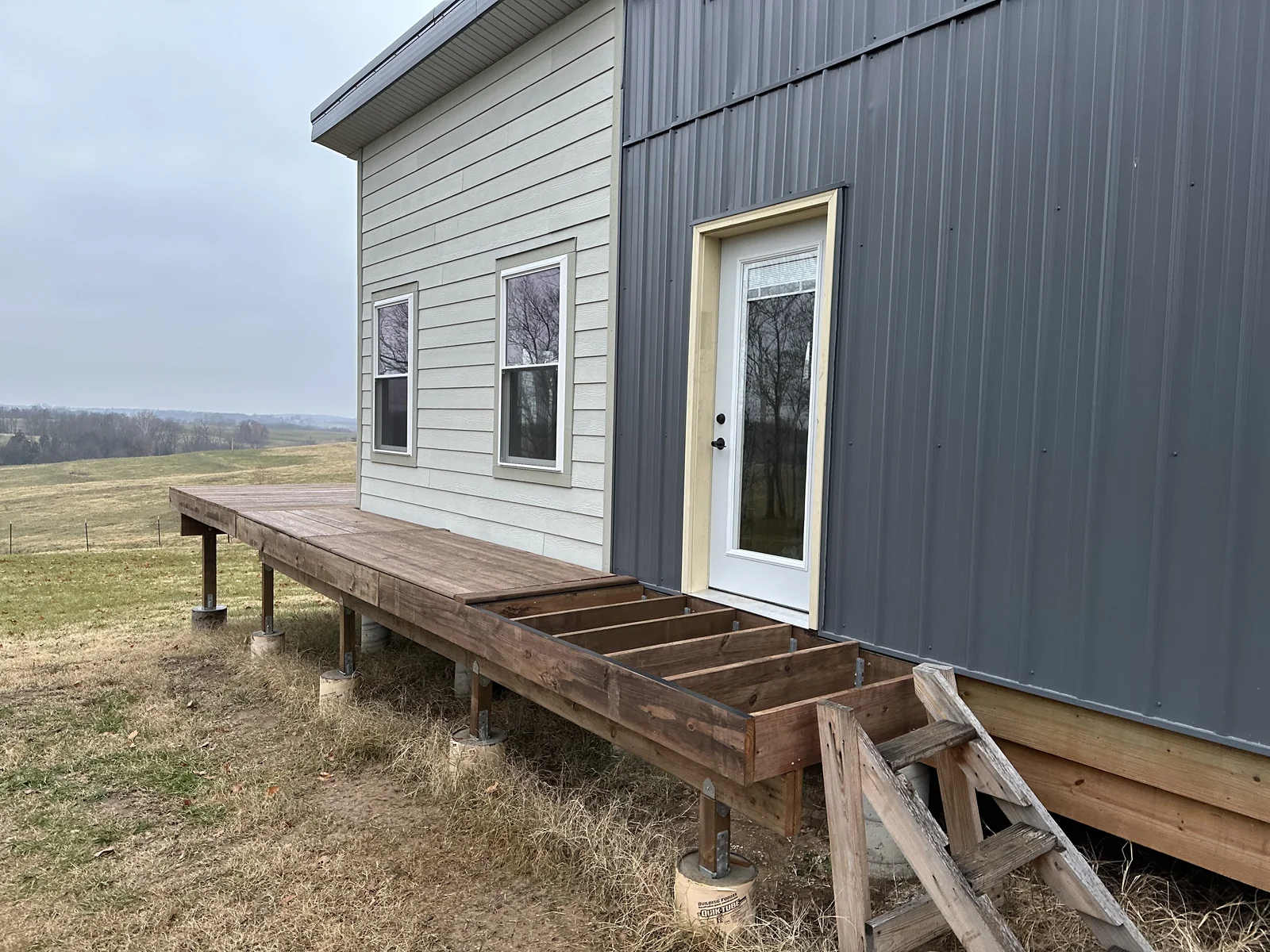 A nearly completed wood deck surface outside the front door of Katy Manor.