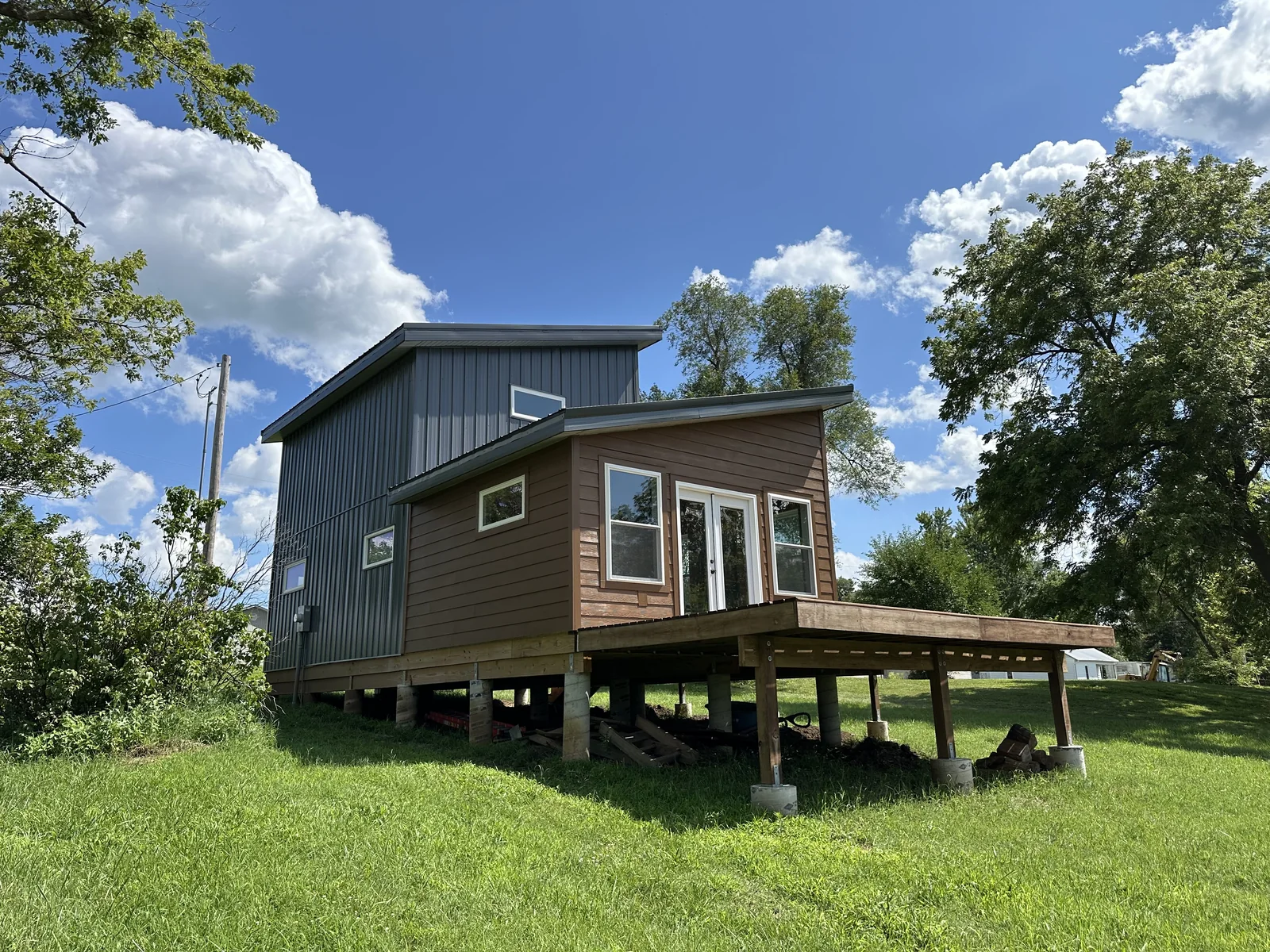 Rear view of Katy Manor with completed siding, windows, and deck structure.